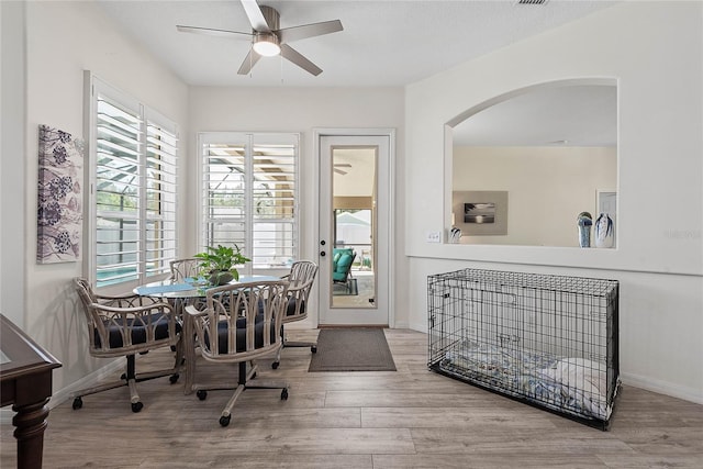 65 Esperanto Dr, Palm Coast, FL 32164 - dining room with arched walkways, wood finished floors, baseboards, and ceiling fan