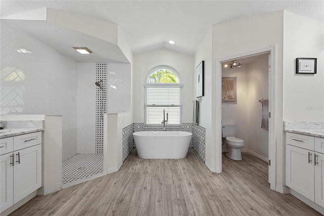 65 Esperanto Dr, Palm Coast, FL 32164 - full bathroom with toilet, lofted ceiling, walk in shower, wood finished floors, and vanity