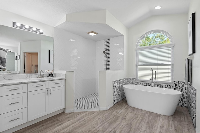 65 Esperanto Dr, Palm Coast, FL 32164 - full bath with wood finished floors, a freestanding tub, vanity, and walk in shower