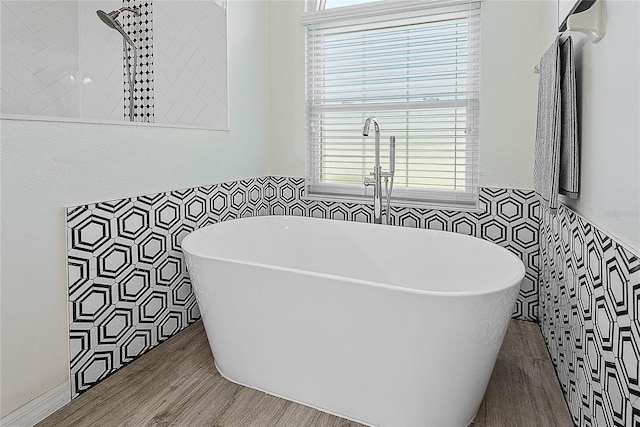 65 Esperanto Dr, Palm Coast, FL 32164 - bathroom with tile walls, wood finished floors, wainscoting, and a freestanding bath