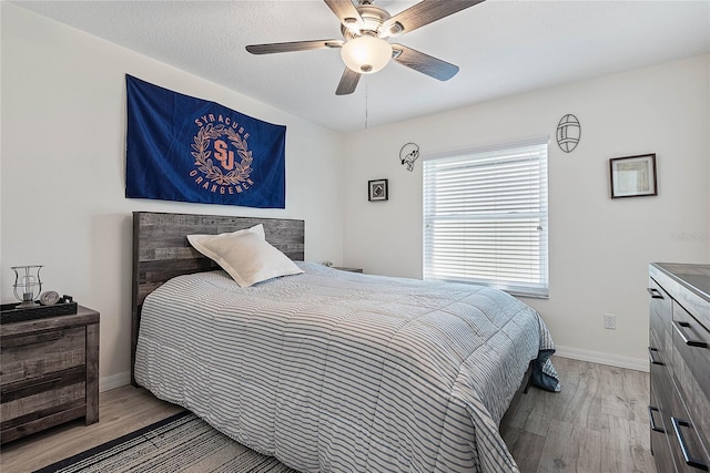 65 Esperanto Dr, Palm Coast, FL 32164 - bedroom with wood finished floors, a ceiling fan, and baseboards