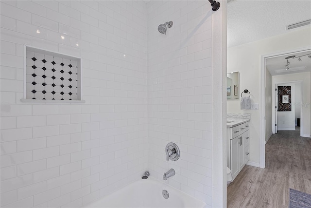 65 Esperanto Dr, Palm Coast, FL 32164 - full bathroom with a textured ceiling,  shower combination, visible vents, wood finished floors, and vanity