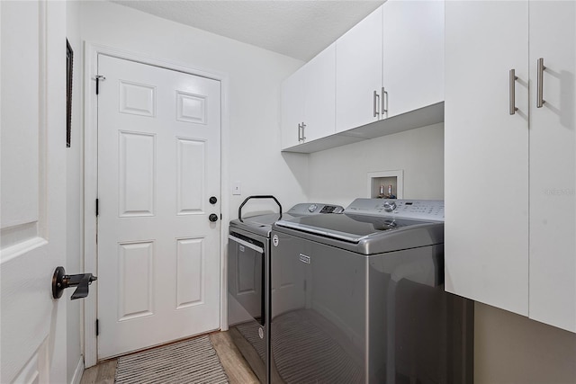 65 Esperanto Dr, Palm Coast, FL 32164 - laundry room featuring cabinet space, light wood-style floors, and washing machine and clothes dryer