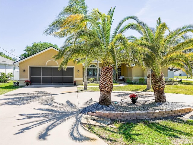 65 Esperanto Dr, Palm Coast, FL 32164 - view of front of home featuring concrete driveway, a garage, a front yard, and stucco siding