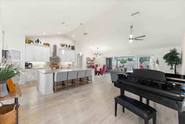40 Woodborn Ln, Palm Coast, FL 32164 - living room with a ceiling fan, light wood-style floors, and high vaulted ceiling