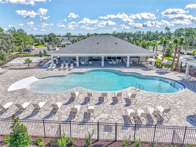 pool featuring a patio and fence