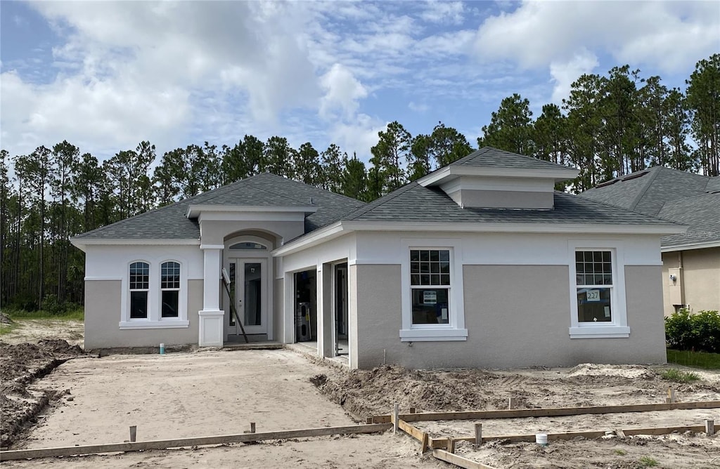 227 Hawthorn Ave, Palm Coast, FL 32164 - view of front of property with a shingled roof, stucco siding, and an attached garage