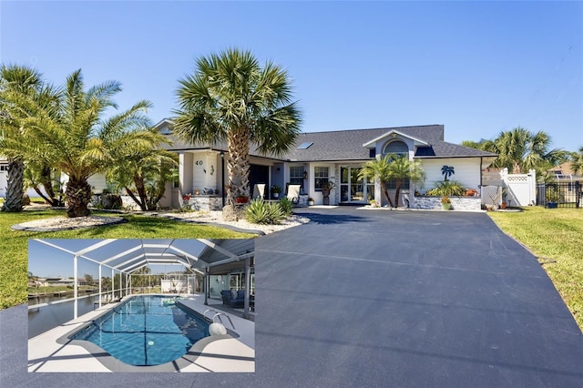 40 Cortes Ct, Palm Coast, FL 32137 - view of swimming pool featuring a gate and glass enclosure