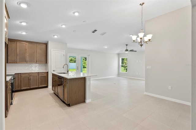 55 Ryan Dr, Palm Coast, FL 32164 - kitchen with a sink, stainless steel dishwasher, a chandelier, decorative backsplash, and light countertops