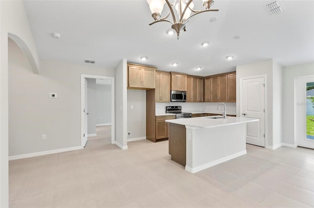 55 Ryan Dr, Palm Coast, FL 32164 - kitchen with stainless steel appliances, a sink, light countertops, a center island with sink, and baseboards