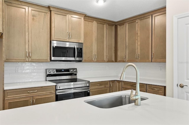 55 Ryan Dr, Palm Coast, FL 32164 - kitchen with appliances with stainless steel finishes, a sink, light countertops, backsplash, and brown cabinetry