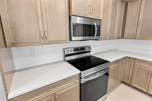 55 Ryan Dr, Palm Coast, FL 32164 - kitchen with appliances with stainless steel finishes, tasteful backsplash, and light countertops