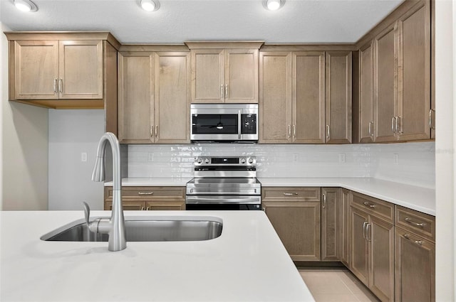 55 Ryan Dr, Palm Coast, FL 32164 - kitchen with stainless steel appliances, a sink, light countertops, and tasteful backsplash