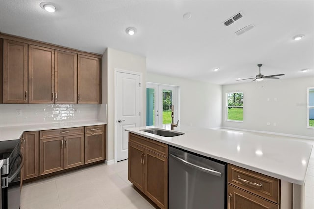 55 Ryan Dr, Palm Coast, FL 32164 - kitchen featuring stainless steel dishwasher, light countertops, backsplash, a ceiling fan, and stove