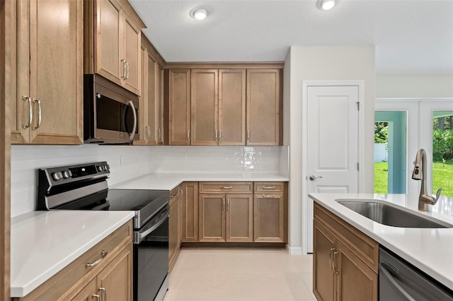 55 Ryan Dr, Palm Coast, FL 32164 - kitchen with stainless steel appliances, a sink, tasteful backsplash, and light countertops
