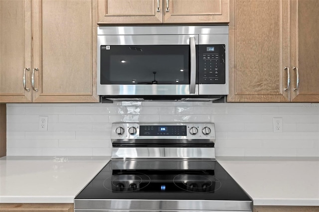 55 Ryan Dr, Palm Coast, FL 32164 - kitchen with appliances with stainless steel finishes, backsplash, and light countertops