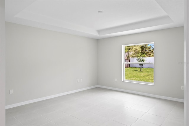 55 Ryan Dr, Palm Coast, FL 32164 - empty room with a tray ceiling, light tile patterned flooring, and baseboards