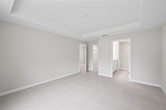 55 Ryan Dr, Palm Coast, FL 32164 - unfurnished bedroom with a raised ceiling, baseboards, and a spacious closet