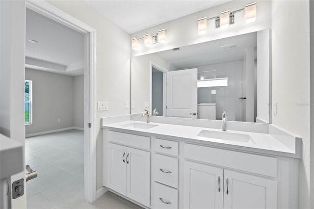 55 Ryan Dr, Palm Coast, FL 32164 - bathroom featuring double vanity, baseboards, tiled shower, and tile patterned flooring