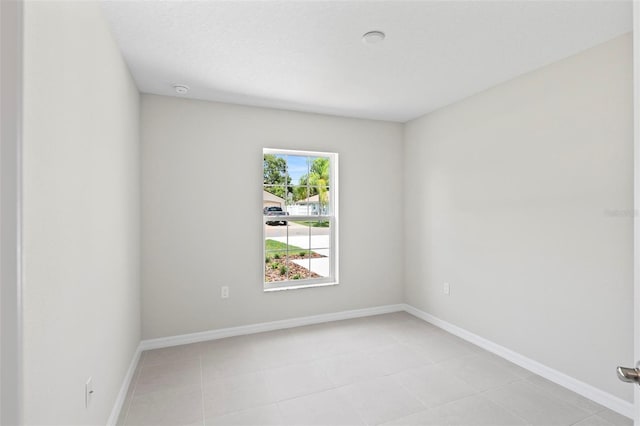55 Ryan Dr, Palm Coast, FL 32164 - spare room with light tile patterned floors and baseboards