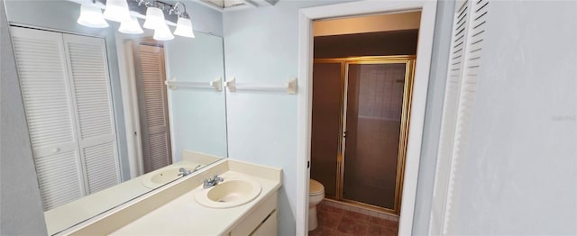 bathroom featuring tile patterned flooring, a closet, toilet, and a stall shower