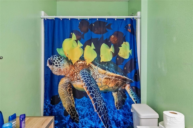 47 Raleigh Dr, Palm Coast, FL 32164 - interior details with curtained shower, toilet, and a textured wall