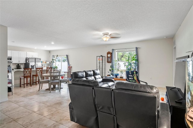 47 Raleigh Dr, Palm Coast, FL 32164 - living area with a wealth of natural light, a ceiling fan, a textured ceiling, and light tile patterned flooring
