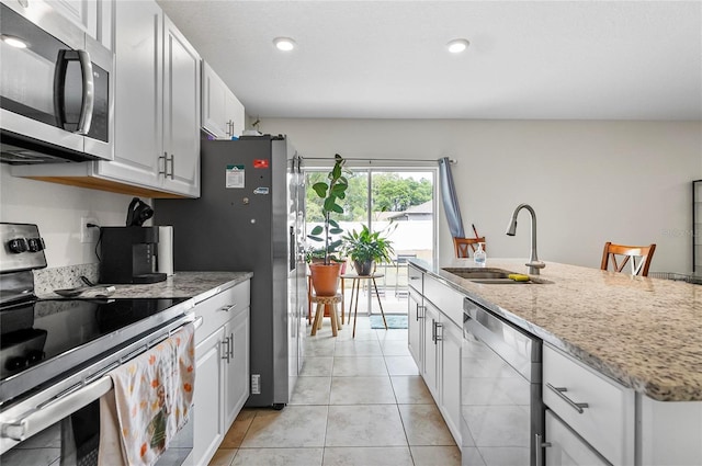 47 Raleigh Dr, Palm Coast, FL 32164 - kitchen featuring white cabinets, stainless steel appliances, light stone countertops, and a sink