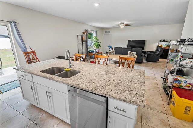 47 Raleigh Dr, Palm Coast, FL 32164 - kitchen featuring stainless steel dishwasher, a kitchen island with sink, ceiling fan, a sink, and white cabinetry