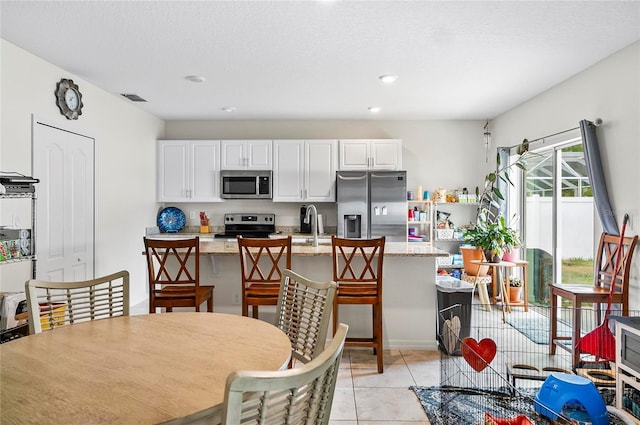 47 Raleigh Dr, Palm Coast, FL 32164 - dining room featuring light tile patterned floors, visible vents, and recessed lighting