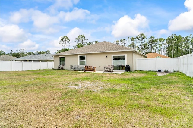47 Raleigh Dr, Palm Coast, FL 32164 - back of property with stucco siding, a lawn, a patio area, and a fenced backyard