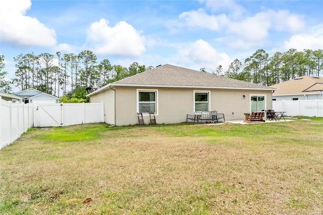 47 Raleigh Dr, Palm Coast, FL 32164 - rear view of property featuring a yard, stucco siding, a fenced backyard, and a patio area