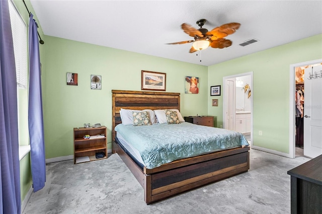 47 Raleigh Dr, Palm Coast, FL 32164 - bedroom with a spacious closet, ensuite bathroom, baseboards, visible vents, and a ceiling fan