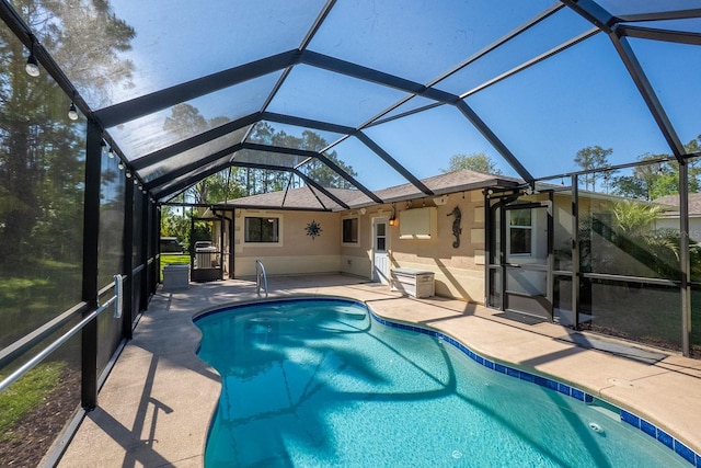 pool featuring a patio and glass enclosure