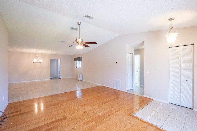 unfurnished living room featuring visible vents, a ceiling fan, and wood finished floors