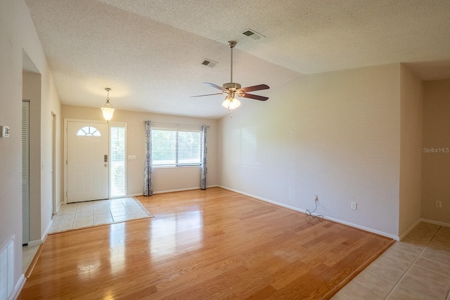 interior space with a ceiling fan, visible vents, and light wood-style floors