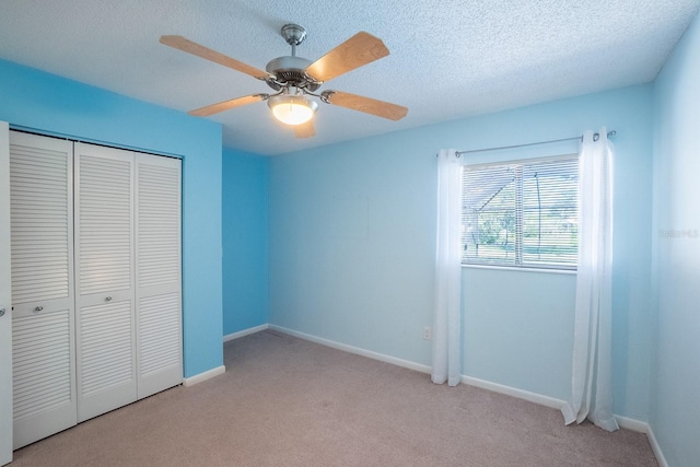 unfurnished bedroom with baseboards, light carpet, and a closet