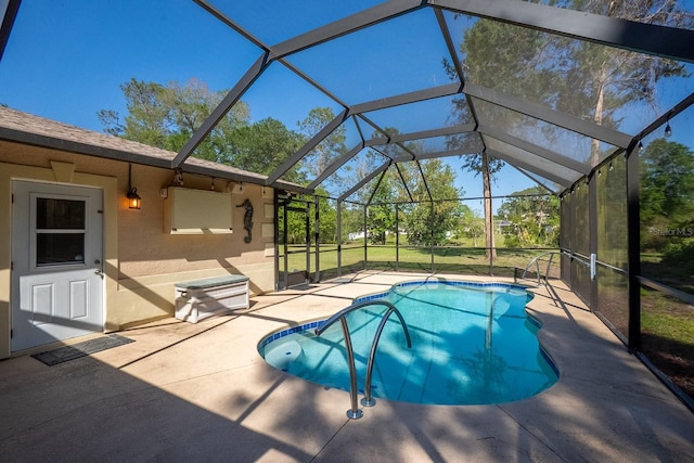 pool with a patio and glass enclosure