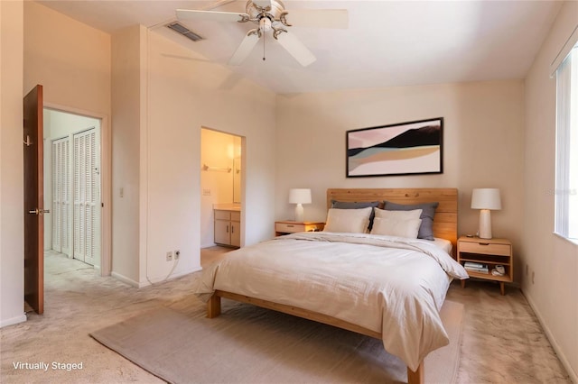 140 Limewood Pl Unit 2, Ormond Beach, FL 32174 - bedroom with light carpet, baseboards, ensuite bathroom, and a ceiling fan