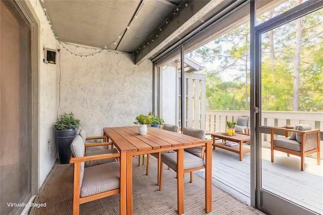 140 Limewood Pl Unit 2, Ormond Beach, FL 32174 - sunroom / solarium with rail lighting and outdoor dining space