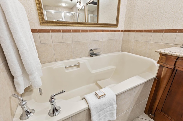 200 Ocean Crest Dr Unit 726, Palm Coast, FL 32137 - full bathroom with vanity, wallpapered walls, tile walls, a bathtub, and wainscoting
