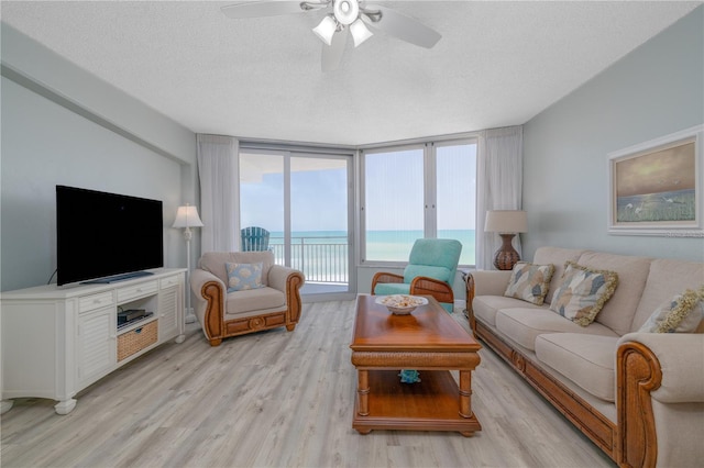 1155 Ocean Shore Blvd Unit 702, Ormond Beach, FL 32176 - living room featuring light wood-style flooring, a textured ceiling, and a ceiling fan