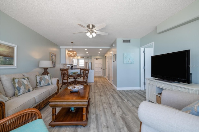 1155 Ocean Shore Blvd Unit 702, Ormond Beach, FL 32176 - living area with visible vents, a textured ceiling, light wood-style floors, and ceiling fan