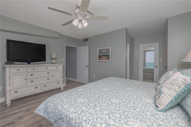1155 Ocean Shore Blvd Unit 702, Ormond Beach, FL 32176 - bedroom featuring baseboards, visible vents, wood finished floors, and a textured ceiling
