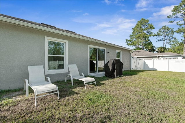64 Princess Ruth Ln, Palm Coast, FL 32164 - rear view of house featuring fence, a yard, and stucco siding