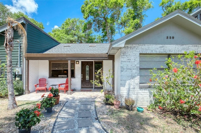 330 Wall Ave, Ormond Beach, FL 32174 - view of front facade featuring brick siding and a shingled roof