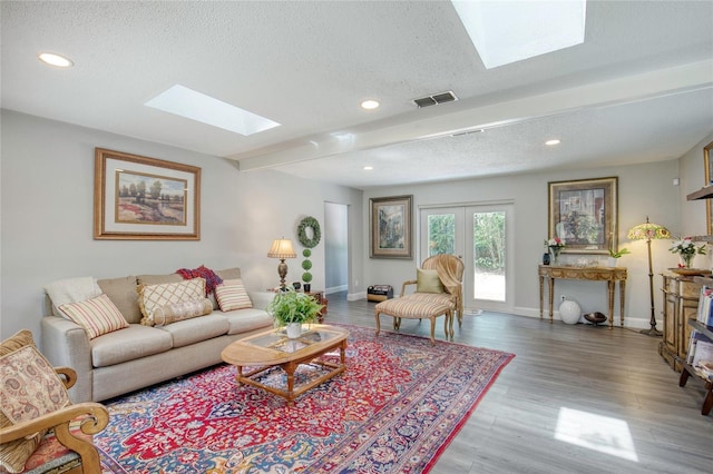 330 Wall Ave, Ormond Beach, FL 32174 - living room with a textured ceiling, a skylight, visible vents, and wood finished floors