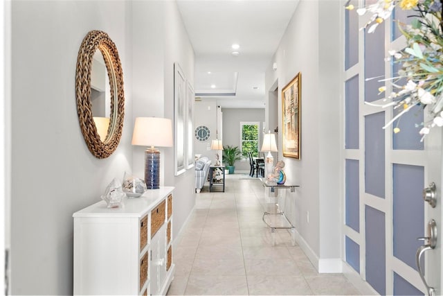 hall featuring recessed lighting and baseboards