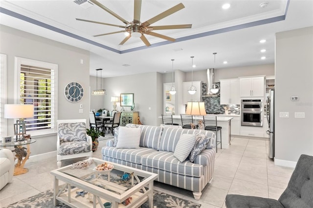 living room featuring recessed lighting, a raised ceiling, a ceiling fan, and light tile patterned floors