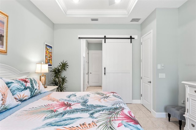 bedroom featuring a barn door, a raised ceiling, visible vents, and light tile patterned flooring